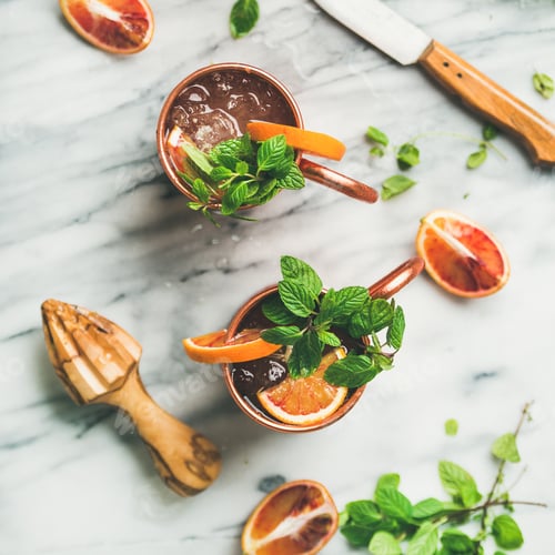 Preview: Blood orange Moscow mule alcohol cocktails, marble background, square crop