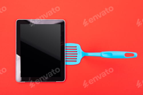 Preview: Digital tablet on blue blade isolated on red background