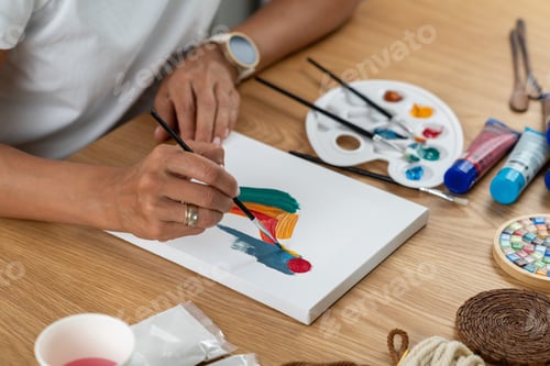 Preview: Woman painting indoors in a relaxed craft setting