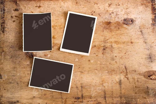 Preview: Set of old photos on a wooden background, top view