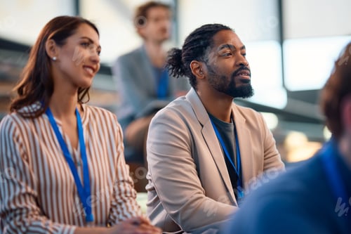 Preview: Black businessman and his colleagues attending an education event in a convention center.