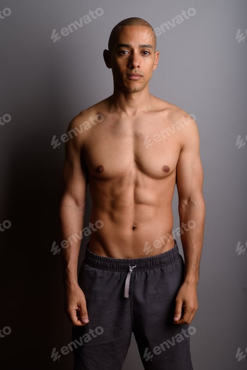 Preview: Handsome bald man shirtless against gray background