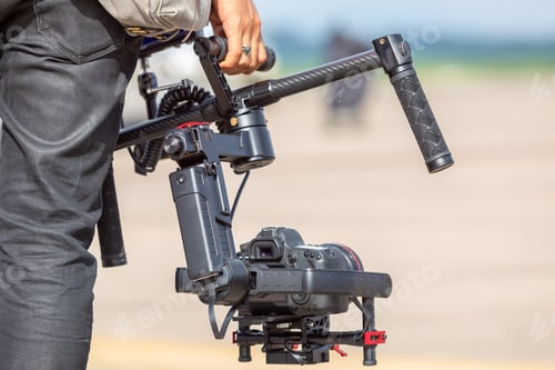 Preview: Videographer shooting with gimbal, Videographer filmmaker cinematographer axis gimbal and dslr.