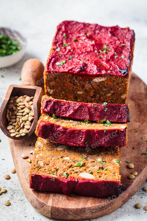 Preview: Lentil vegan meat oaf sliced on wooden board. Christmas recipe.
