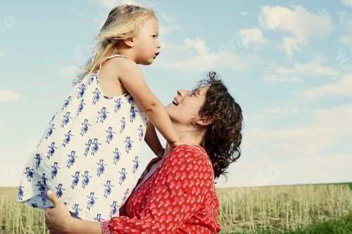 Preview: Woman in field face to face with toddler daughter