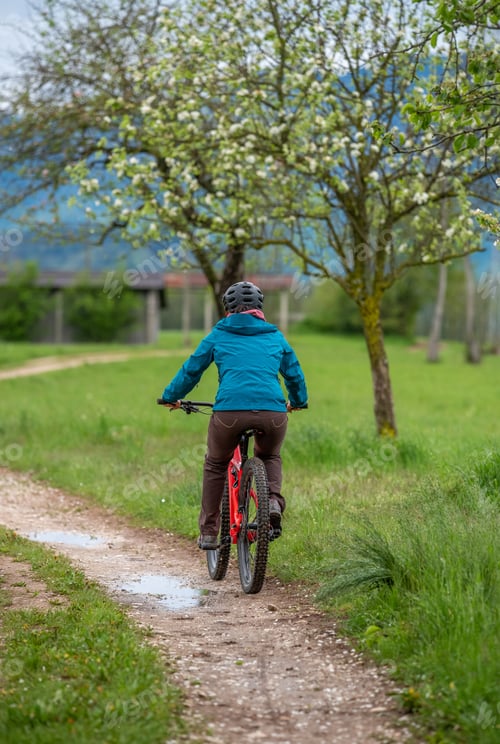 Preview: A young female is cycling through the countryside