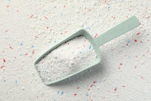 Preview: Scoop with washing powder on washing powder background