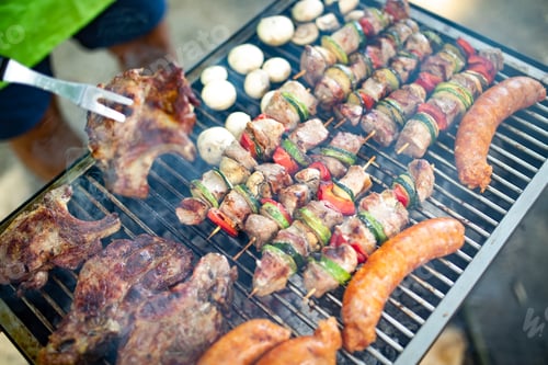 Preview: Grilled meat with vegetables over the coal on barbecue
