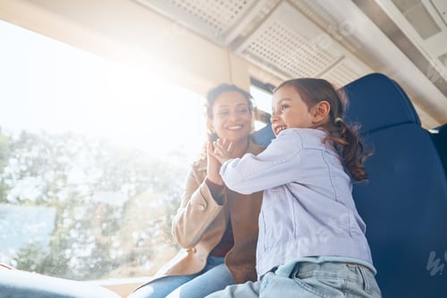Preview: Happy mother with little daughter having fun while traveling by train together