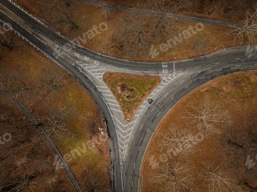 Preview: Top down view over an intersection, in a triangular shape, on a cloudy day in autumn.
