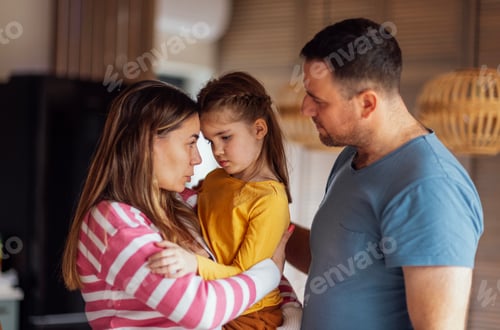 Preview: Young parents comfort their cute daughter. Beautiful woman hugs and talks to little girl