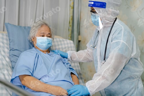 Preview: Asian doctor wearing face shield and PPE suit new normal to check patient protect safety infection