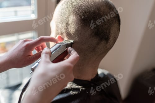 Preview: Woman barber cutting hair using razor