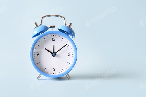 Preview: Old-fashioned blue alarm clock on blue background.