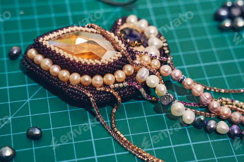 Preview: Beautiful multicolor jewelry lying on the table