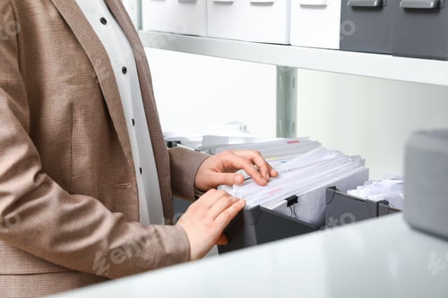 Preview: Woman taking documents from folder in archive, closeup
