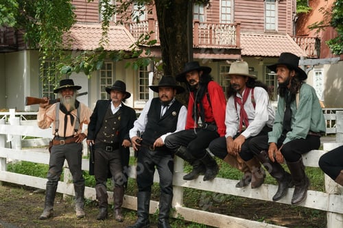 Preview: Brutal cowboy with revolver, gunfight on ranch, rural background.