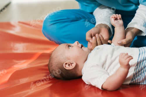 Preview: Physiotherapist performing exercises on a five month old baby