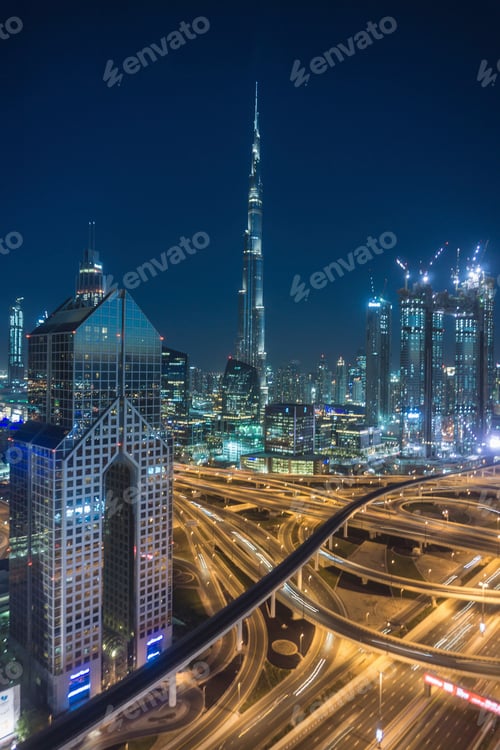 Preview: City skyline at night with illuminated skyscrapers and bustling traffic