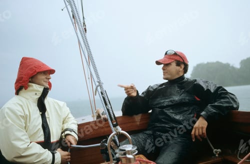 Preview: Two people having a chat on a boat amidst misty weather.
