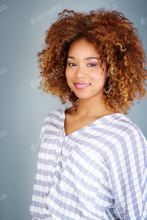 Preview: Full of self confidence. Studio shot of a young businesswoman against a gray background.