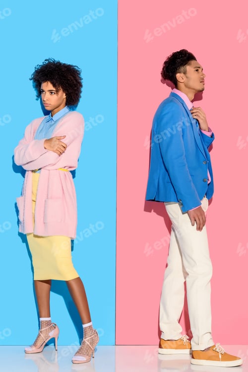 Preview: Pensive couple standing in distance of each other on pink and blue background