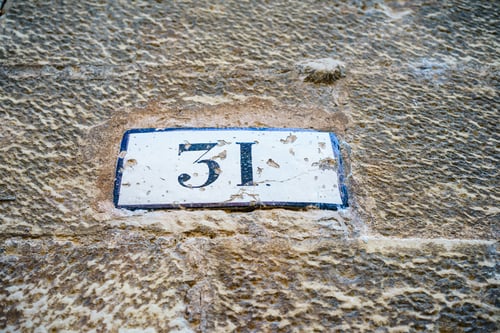 Preview: Closeup shot of worn-out metal signboard with house number 31