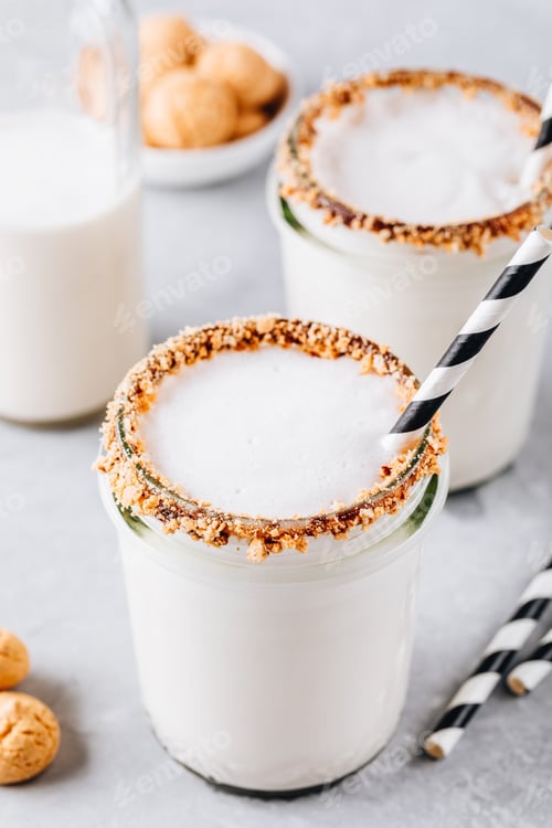 Preview: Vanilla milkshake with crispy cookies in glass mason jar on gray background