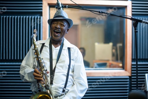 Preview: Male musician in recording studio, holding saxophone, laughing