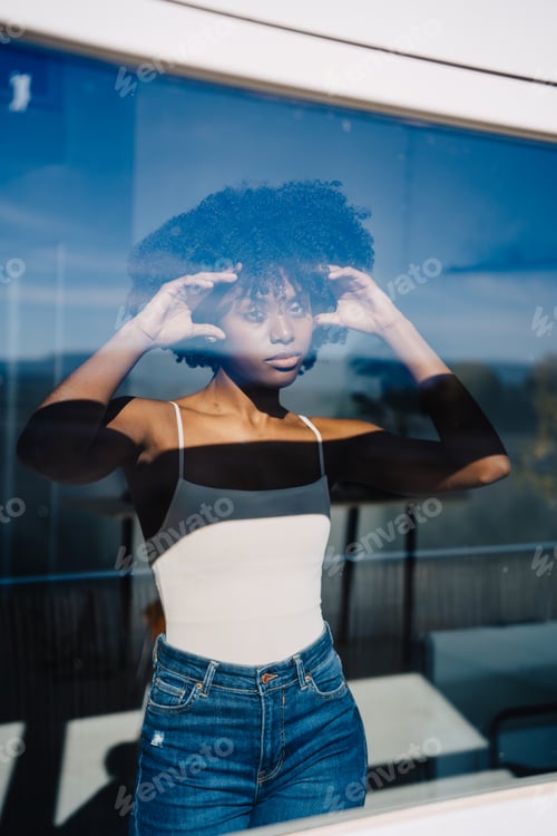 Preview: Trendy black woman looking at window