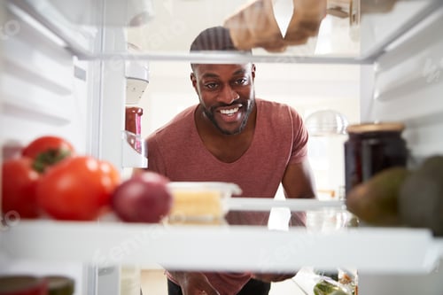 Preview: View Looking Out From Inside Of Refrigerator As Man Opens Door And Unpacks Shopping Bag Of Food
