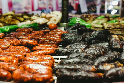 Preview: Sausages and black pudding roasted in a barbecue.