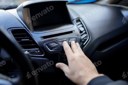 Preview: a man's hand reaches out to the dashboard of the car and presses the button with his finger
