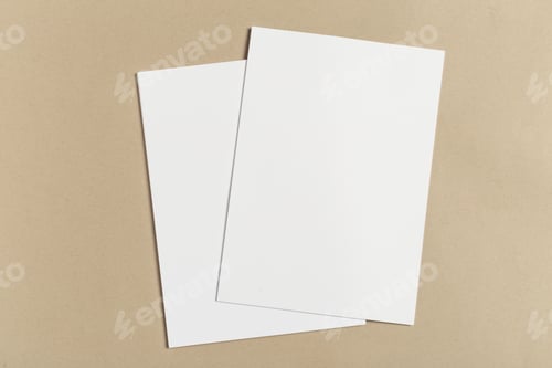 Preview: Blank sheets of paper placed on a brown surface for crafting or writing activities