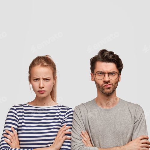 Preview: Negative human feeling concept. Dissatisfied female and male with arms folded and gloomy expressions
