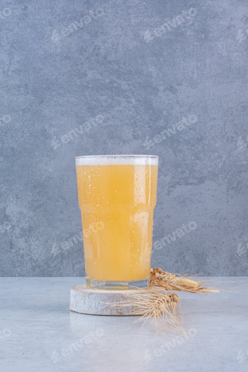 Preview: A glass of beer with wheat on white background