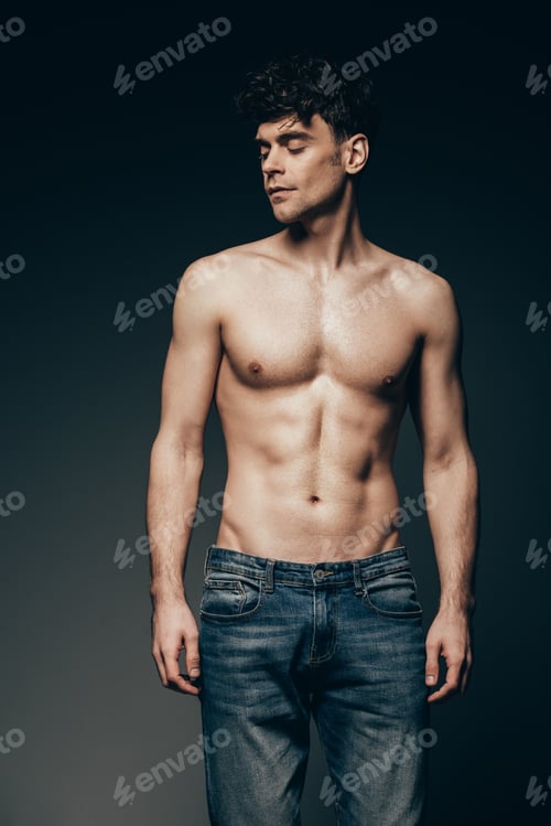 Preview: sexy shirtless muscular man in jeans posing isolated on dark grey