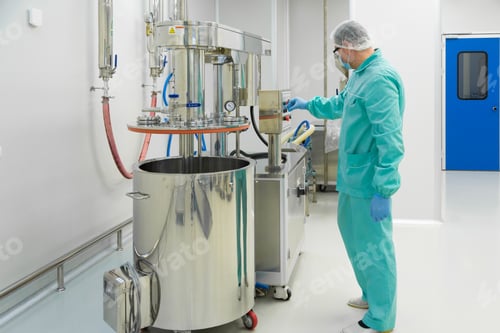 Preview: Pharmaceutical factory man worker in protective clothing working with control panel in sterile