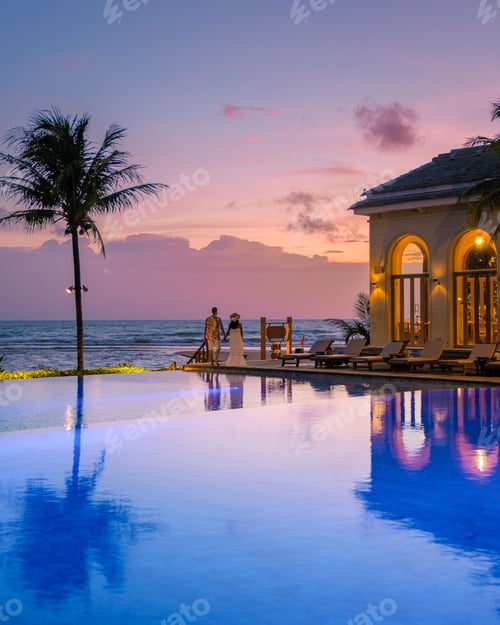 Preview: young couple men and women at the swimming pool during vacation at the tropical island in Thailand