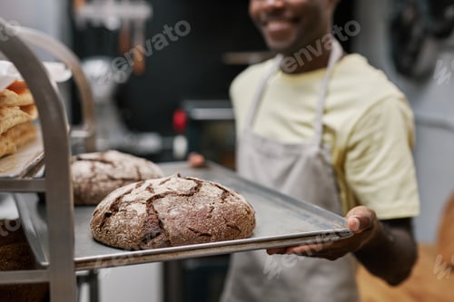 Preview: Baker Holding Tray with Bread