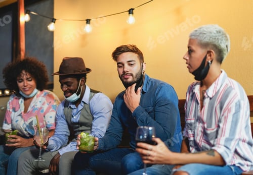Preview: Young multiracial people drinking cocktails at home outdoor on patio
