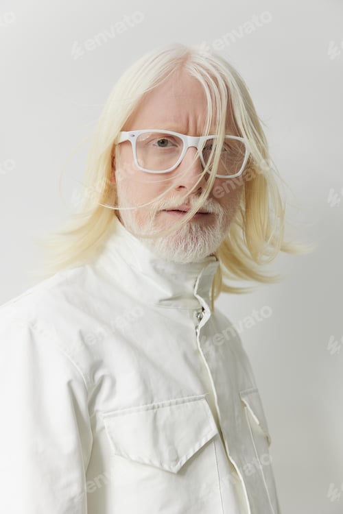 Preview: Portrait of a mature man with long, light colored hair and beard, wearing white clothes against a