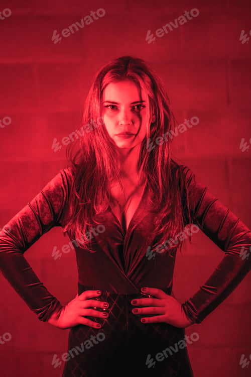 Preview: Red-haired girl in latex, brown and black tight suit on a brick wall