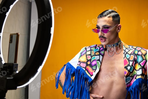Preview: Young non-binary drag queen guy taking a picture of himself with a light ring