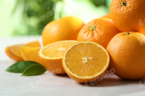 Preview: Ripe oranges on table against blurred background, closeup