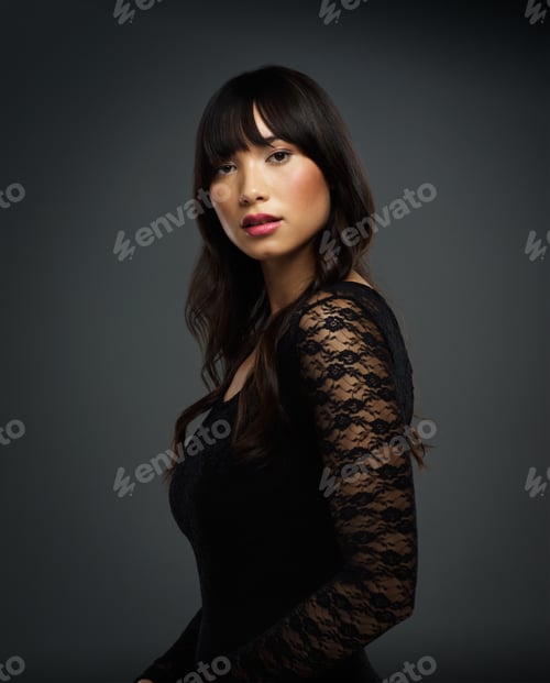 Preview: Studio shot of a beautiful young woman posing against a dark background