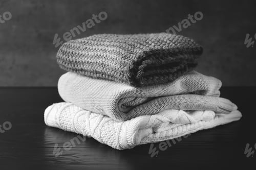 Preview: Stack of warm knitted clothes on table
