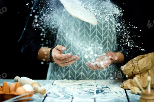 Preview: The man, chef cooks throws the dough, flying, freezing in motion.