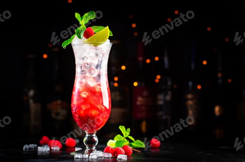Preview: Raspberry lemonade cocktail or mocktail drink with raspberries, syrup, soda, lime, mint and ice