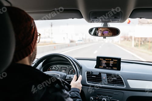Preview: Man driving to work on a cold winter day.